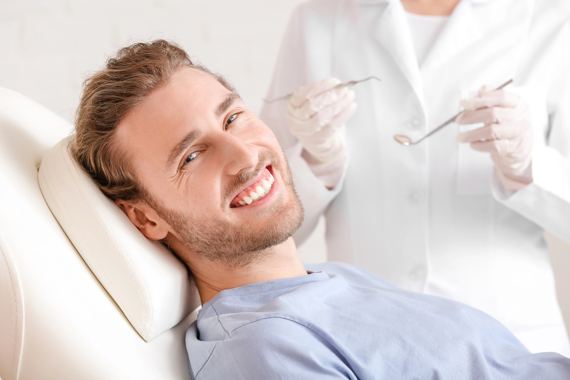Man smiling during teeth whitening appointment at dentist
